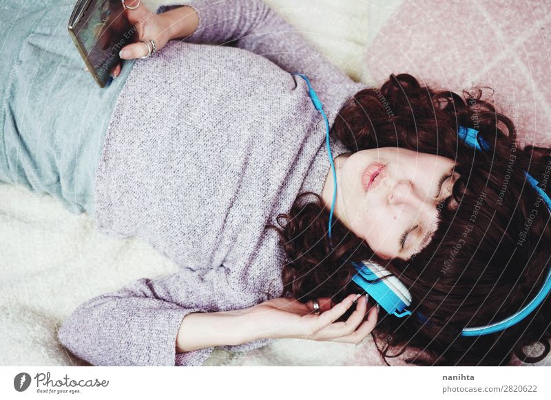 Young brunette woman listening to music in her bedroom youth headphones home lifestyle cool technology pretty face beauty beautiful natural candid real