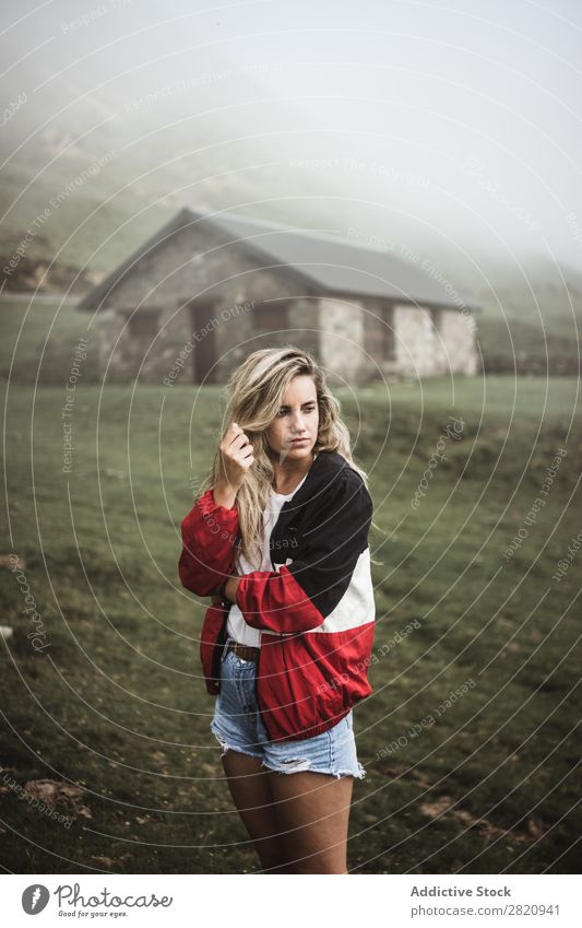 Young woman standing at old building Woman Field Building Considerate Pensive Think Looking away Blonde Nature Human being Landscape Youth (Young adults)