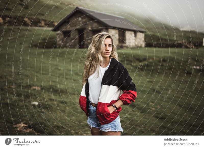 Young woman standing at old building Woman Field Building Considerate Pensive Think Looking away Blonde Nature Human being Landscape Youth (Young adults)