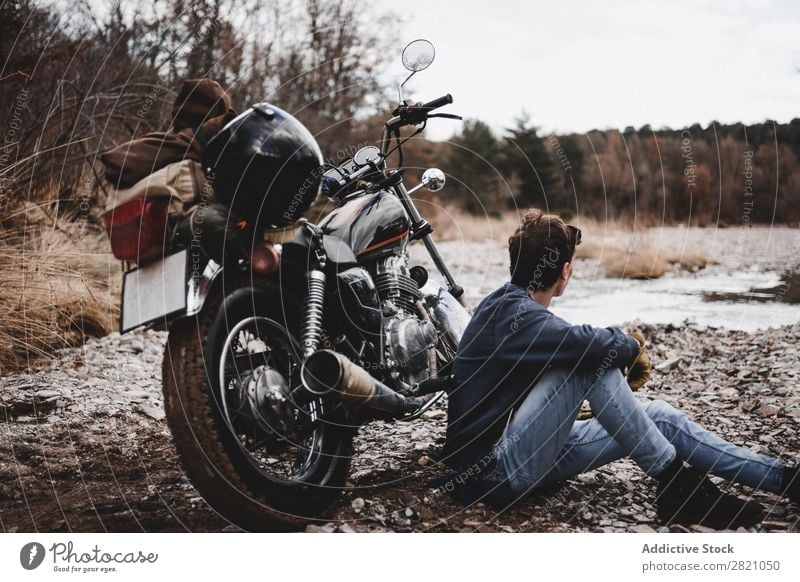 Man sitting near motorcycle Motorcycle Brook Transport Vehicle Freedom Nature Offroad Water Wanderlust Winter Posture traveler Self-confident exploration