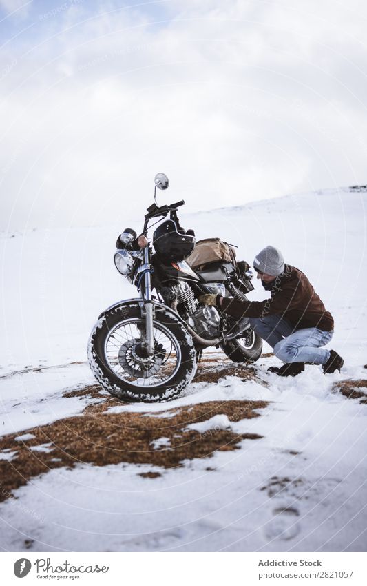 Man with motorcycle in snowy highlands Snow Motorcycle Traveling Transport Adventure Nature Panorama (Format) Tourism Trip Arranged Landscape Valley Highlands
