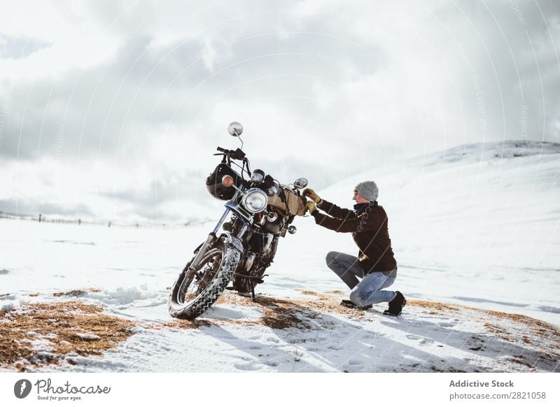 Man with motorcycle in snowy highlands Snow Motorcycle Traveling Transport Adventure Nature Panorama (Format) Tourism Trip Arranged Landscape Valley Highlands