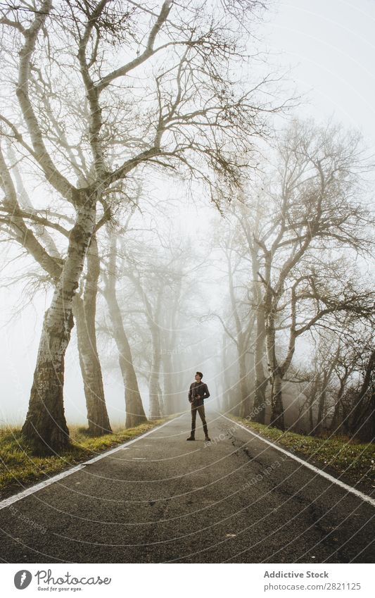 Man standing on foggy road Street Forest Fog Autumn Human being Stand Nature Asphalt Light Landscape Morning Seasons Leaf Beautiful Weather Countries Park