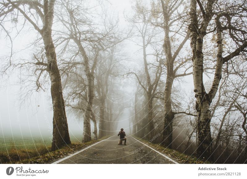 Man standing on foggy road Street Forest Fog Autumn Human being Stand Nature Asphalt Light Landscape Morning Seasons Leaf Beautiful Weather Countries Park