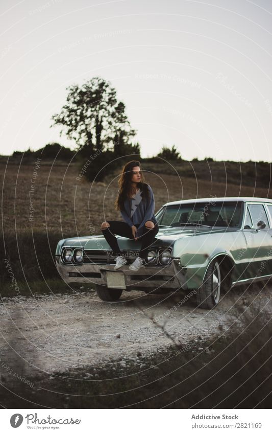 Woman sitting on a car Car Street Field Vacation & Travel Landscape Human being Transport Vehicle Tourism Trip fresh air Gravel Easygoing Open Door Retro Grass