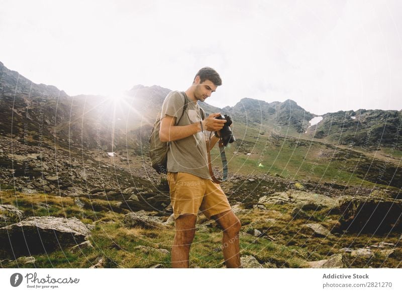 Man browsing camera in mountains Photographer Mountain Camera Nature Landscape Photography Hiking Tourist Vacation & Travel Professional Tourism Adventure