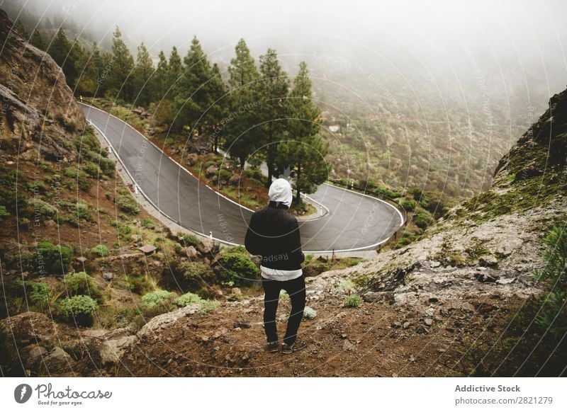 Man looking at mountain road Street Mountain Hill Stand Adventure Nature Vacation & Travel Action Extreme Landscape Success Freedom Top Vantage point Lifestyle