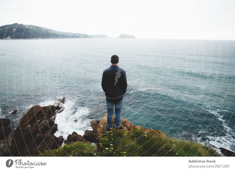 Man on cliff looking at sea Cliff Ocean Vantage point Stand seascape Water Nature Vacation & Travel Landscape Tourism Rock Beautiful Coast Loneliness