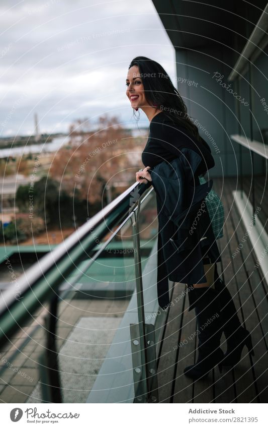Cheerful woman standing at handrail Woman pretty Youth (Young adults) Beautiful Smiling Stand Balcony Building Modern Contemporary Brunette Attractive