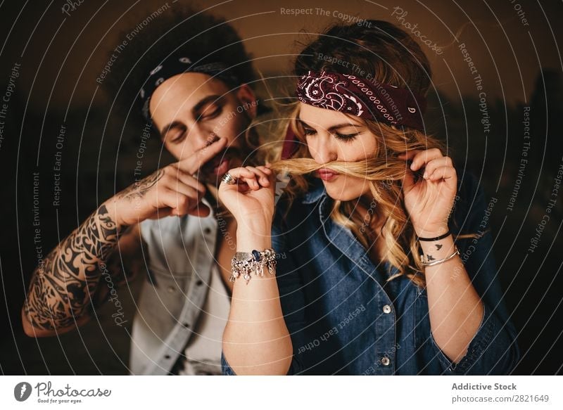 Couple making moustache with hair and finger Joy Hair Wind having fun Portrait photograph Fingers Hair and hairstyles Tattoo Smiling pretty Beautiful Attractive