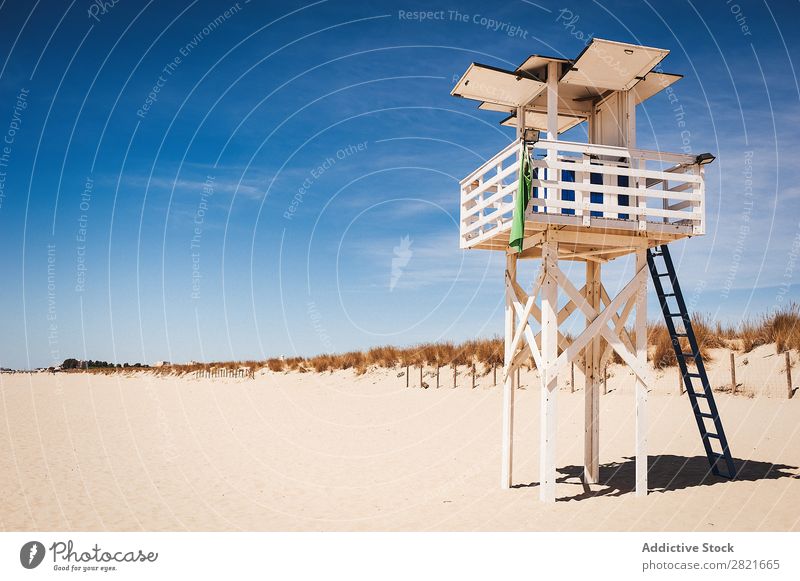 Lifeguard station on sunny beach Tower Beach Construction Sunbeam Summer Day Hot Sand Deserted ababndoned Empty White Wood Blue sky Colour Exterior shot