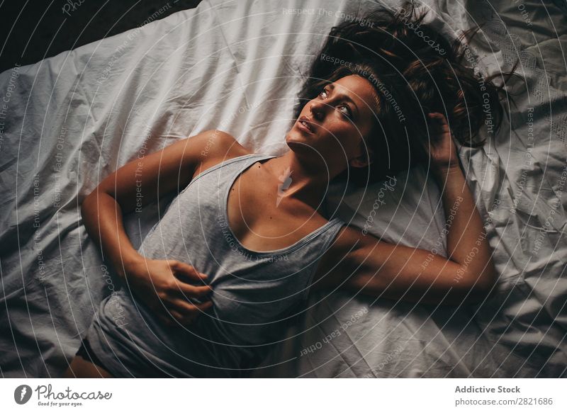Beautiful woman in grey top lying on white bed Woman Bed Above Looking away Portrait photograph Bird's-eye view Top Cleavage Arm Hair Lie (Untruth) To enjoy