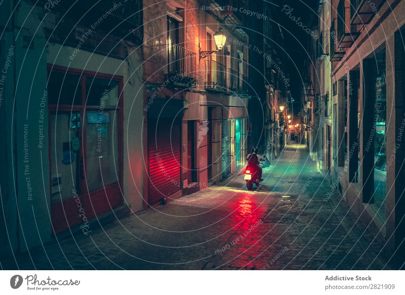 Biker riding on street at night Street Night Dark Town Light Human being Motorcycle Bicycle Rider City Building Architecture Alley Asphalt Vacation & Travel