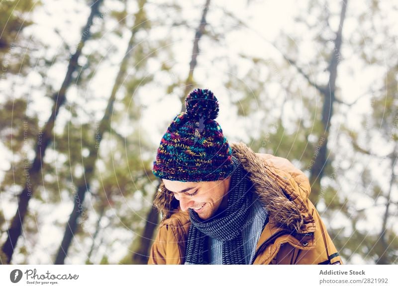 Man playing snowballs in woods Snow ball Playing Forest having fun Entertainment Leisure and hobbies Action Movement Winter Nature Exterior shot