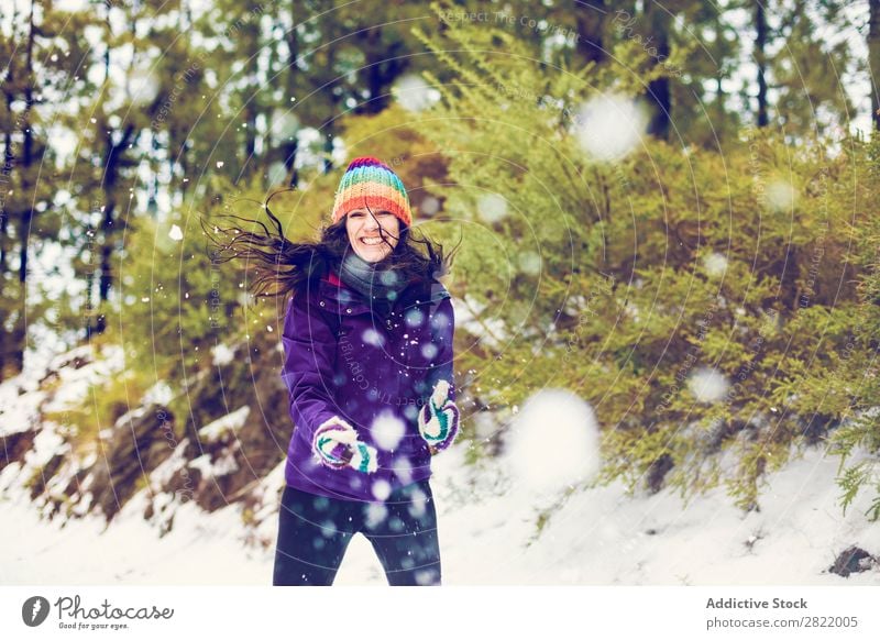 Woman playing snowballs in woods Human being Friendship Snow ball Playing Forest throwing having fun Entertainment Leisure and hobbies Action Movement Winter