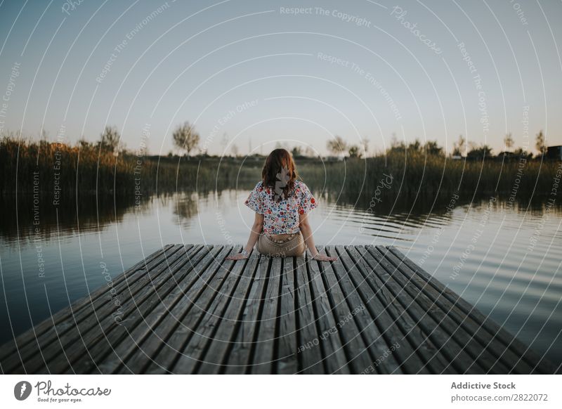 Woman sitting on wooden pier Pond Jetty Sit Youth (Young adults) Water Lake Easygoing Lady Dress Happiness Calm Peaceful Rest Relaxation Dock Wood Romance