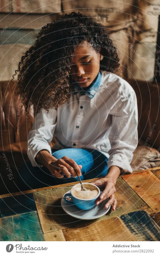 Ethnic woman stirring cup of coffee Woman pretty Beautiful Black Curly Youth (Young adults) Stir Coffee Cup latte Brunette Attractive Human being