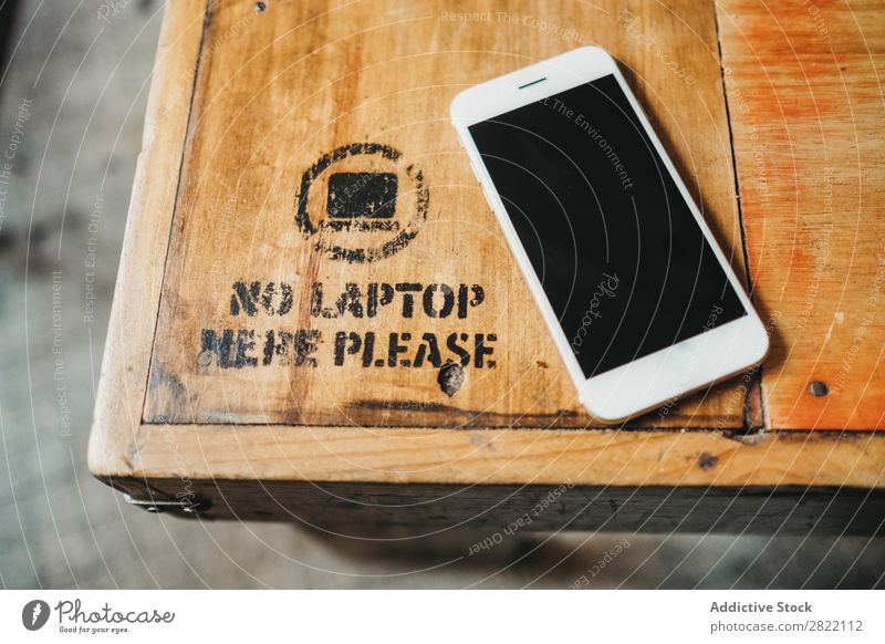 Smartphone on wooden table PDA Table Wood Telephone Mobile Technology White Screen Desk no laptop prohibition device Blank Sign Top Business Modern