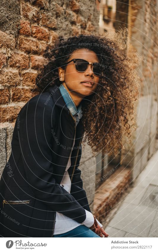 Stylish woman at brick wall Woman pretty Beautiful Ethnic Black Curly African Youth (Young adults) Stand Wall (building) Brick Street Sunglasses Brunette