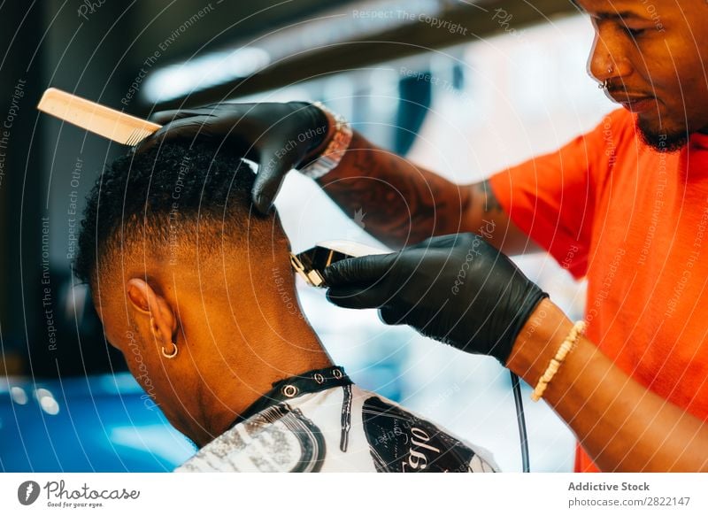Barber using grooming machine Barber shop Customer hair dress Hair salon Hairdresser Black Man Youth (Young adults) Client Hair Stylist Hair and hairstyles