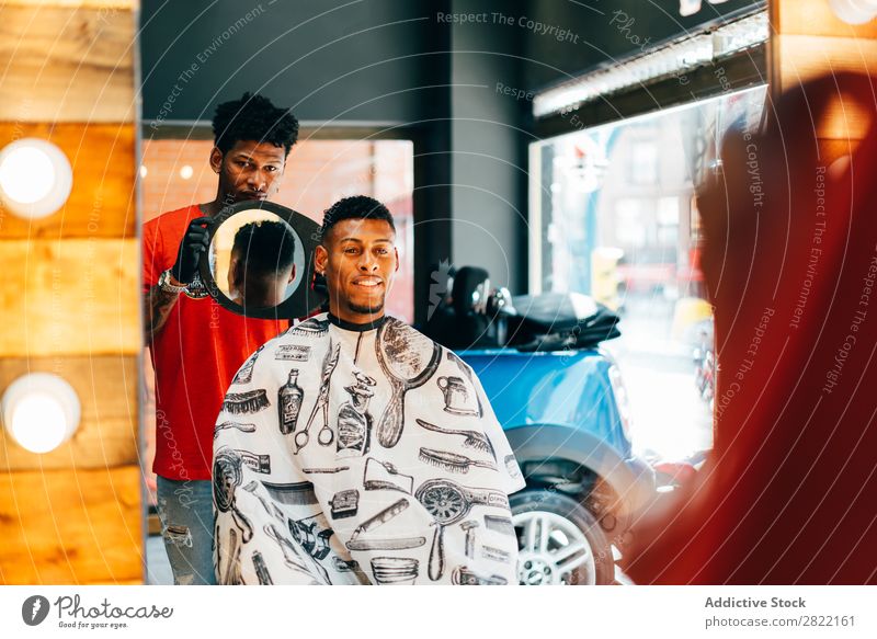 Barber showing haircut to customer Barber shop Customer hair dress Hair Indicate Mirror Reflection salon Hairdresser Black Man Youth (Young adults) Client