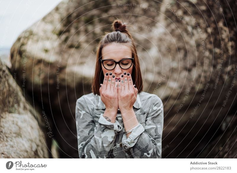Woman in glasses praying at stones Style Nature Stone Rock Stand eyes closed Person wearing glasses Attractive Beautiful Youth (Young adults) Fashion Hipster