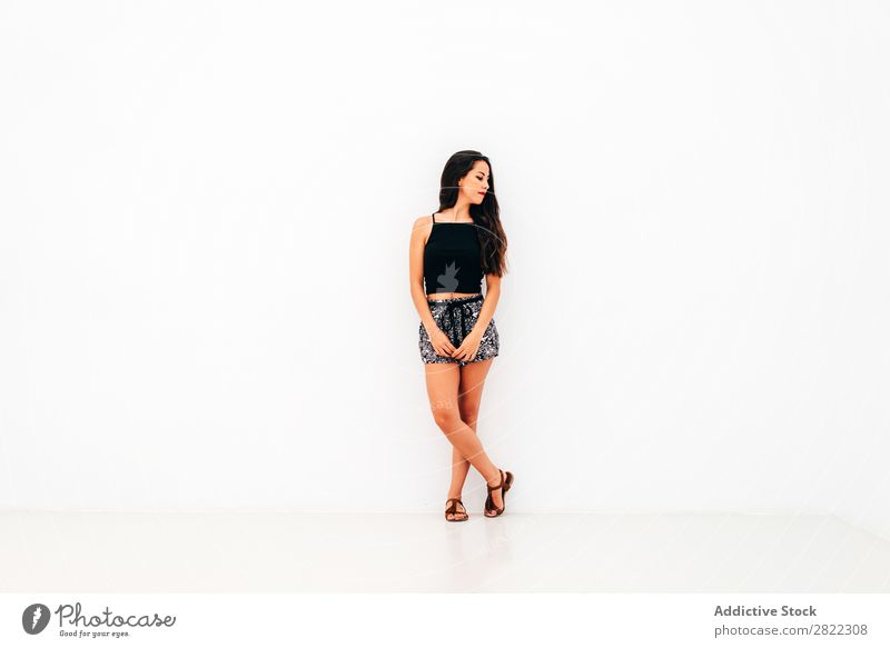 Young woman leaning on white wall Woman pretty Youth (Young adults) Beautiful Stand Lean White Wall (building) Brunette Attractive Human being