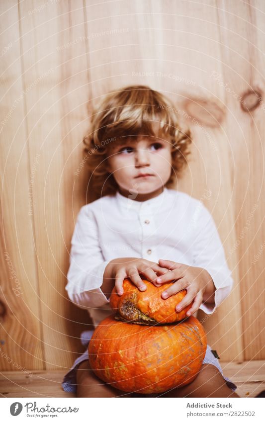 Adorable child posing with pumpkin Child Pumpkin Posture Vacation & Travel Hallowe'en Autumn human face Infancy Magic Fantasy decor Interior design Playful
