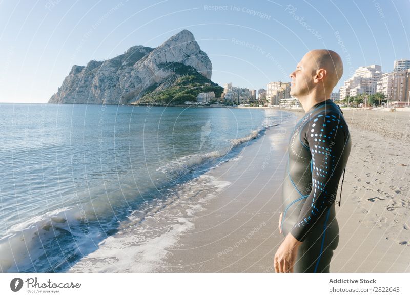 Diver in wet suit standing on beach Man Beach Ocean Vacation & Travel Wetsuit Nature Adventure Sunbathing Leisure and hobbies Beauty Photography Relaxation
