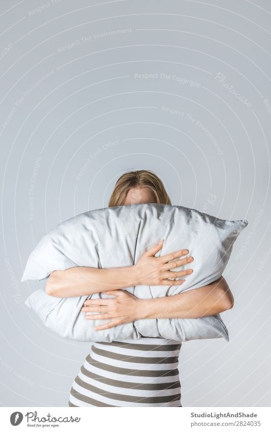 Young woman hugging a gray pillow Lifestyle Beautiful Face Wellness Relaxation Bedroom Human being Woman Adults Arm Hand Blonde Stripe Sleep Cry Thin Modern