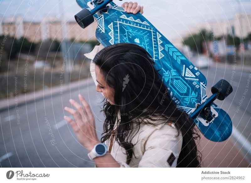 Brunette girl with longboard in the street Caucasian Town Board Cool (slang) Hip & trendy Woman 1 Coast Leisure and hobbies Girl Exterior shot Street Lifestyle