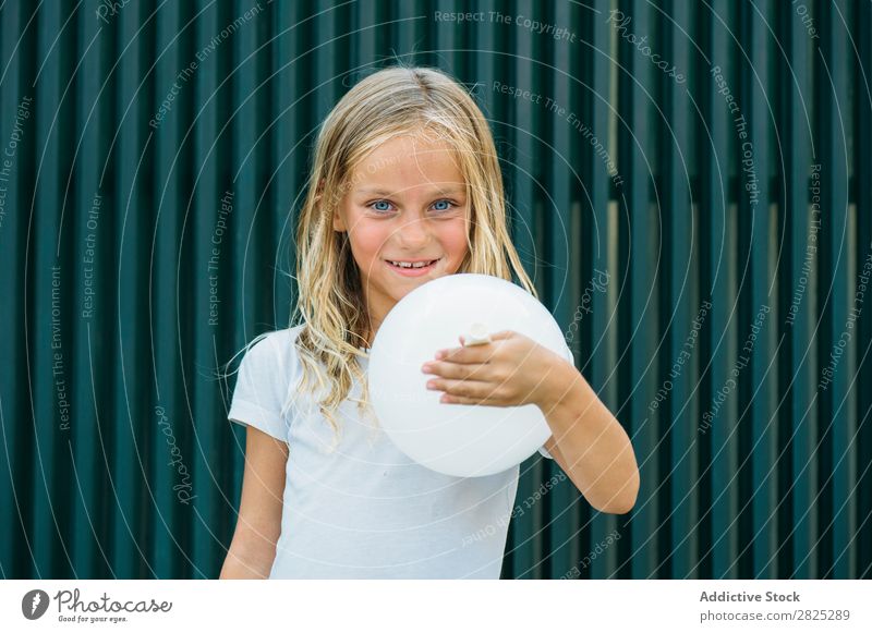 Girl posing with balloon Balloon Blow Posture Earnest Unemotional Town Infancy inflating Birthday Youth (Young adults) Portrait photograph Party facial Child