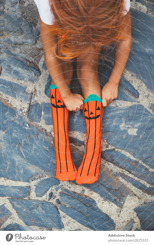 Crop girl putting on creative socks Girl Sock Wear Pumpkin Hallowe'en Autumn Child Clothing Uniqueness Vacation & Travel Fashion Multicoloured Stone Joy