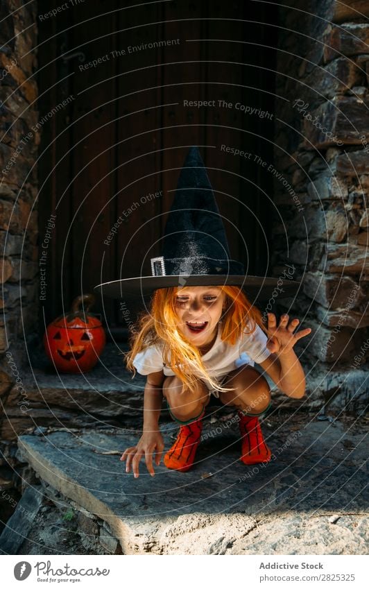Adorable girl posing playfully Girl Hallowe'en pretend terrify Posture Portrait photograph Cheerful House (Residential Structure) Costume Feasts & Celebrations