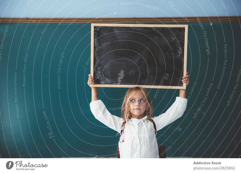 Happy girl standing with chalkboard Girl Classroom Blackboard Stand Hold Scream over head Cheerful Cute Education School Grade (school level) Student