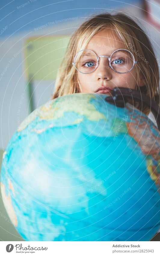 Pupil girl pointing at globe Girl Classroom Sit Globe Geography Indicate Cute Education School Grade (school level) Student Youth (Young adults) Study Child