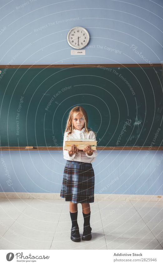 Pupil at chalkboard with books in hand Girl Classroom Blackboard Stand Cheerful Happy Book Chalk Cute Education School Grade (school level) Student
