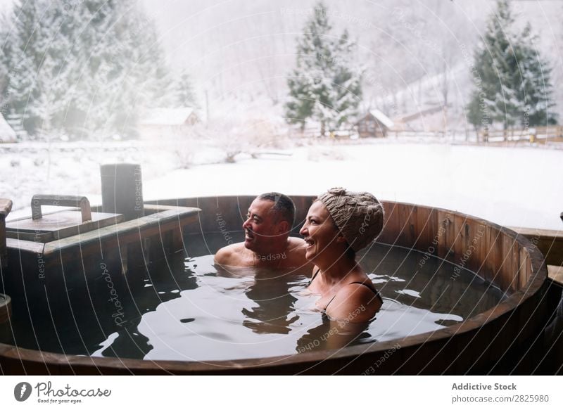 Cheerful adult couple in plunge tub Couple Swimming Nature Winter Water Woman Man Healthy Beautiful Vacation & Travel Romania Float in the water Snow Ice