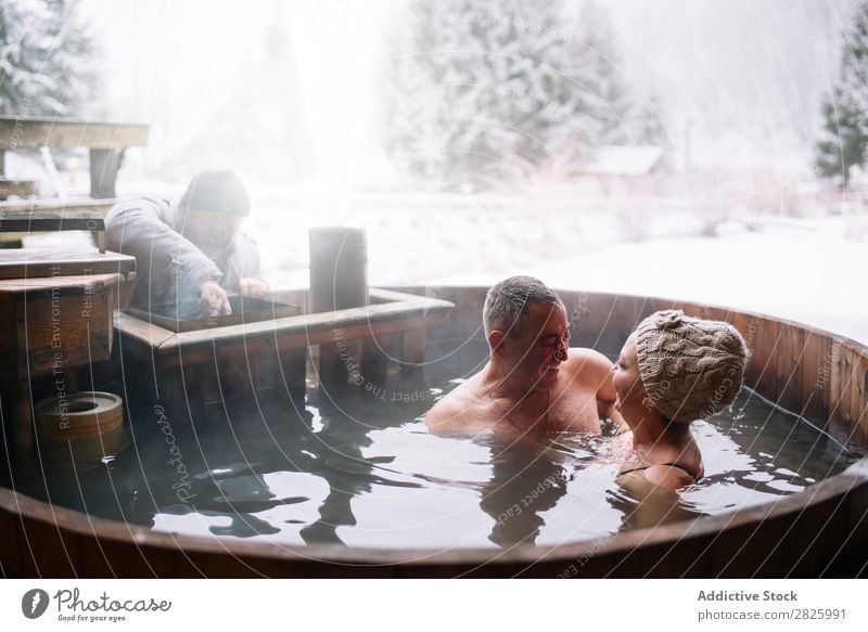 Sensual couple in plunge tub Couple Swimming Nature Winter Water Steam Woman Man Healthy Beautiful Vacation & Travel Romania Float in the water Snow Ice Natural