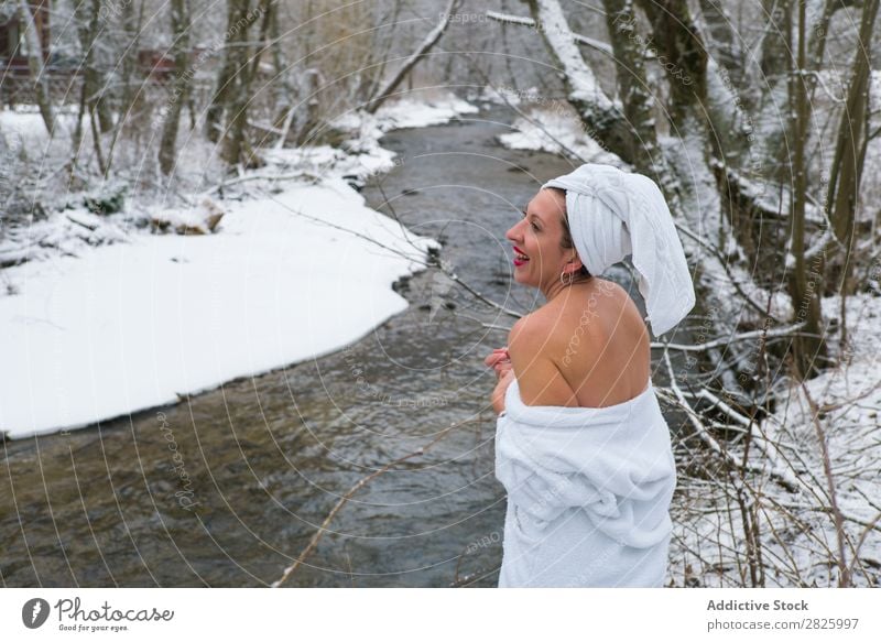 Cheerful woman in towel at river Woman Nature Winter Forest Healthy Bathrobe undressing Happy Towel Beautiful Vacation & Travel Romania Snow Ice Natural