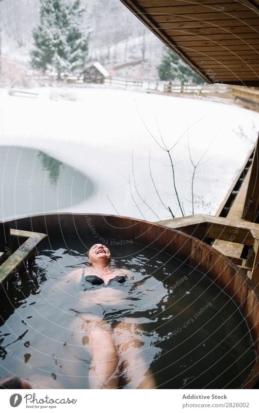 Cheerful woman in outside plunge tub Woman Swimming Nature Winter Water Healthy Beautiful Vacation & Travel Romania Float in the water Snow Ice Natural