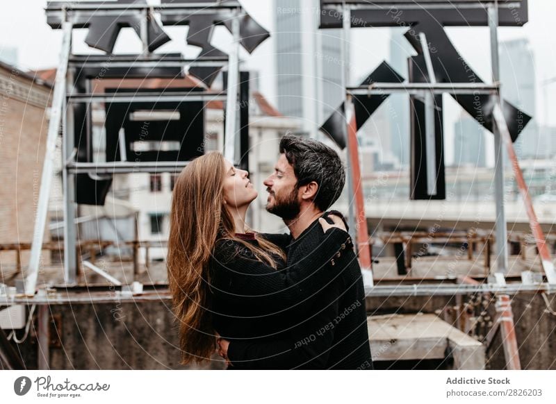 Couple hugging each other on rooftop. Girl kissing guys forehead Embrace City Love Vantage point Kissing Happy romantic Together Beautiful Youth (Young adults)