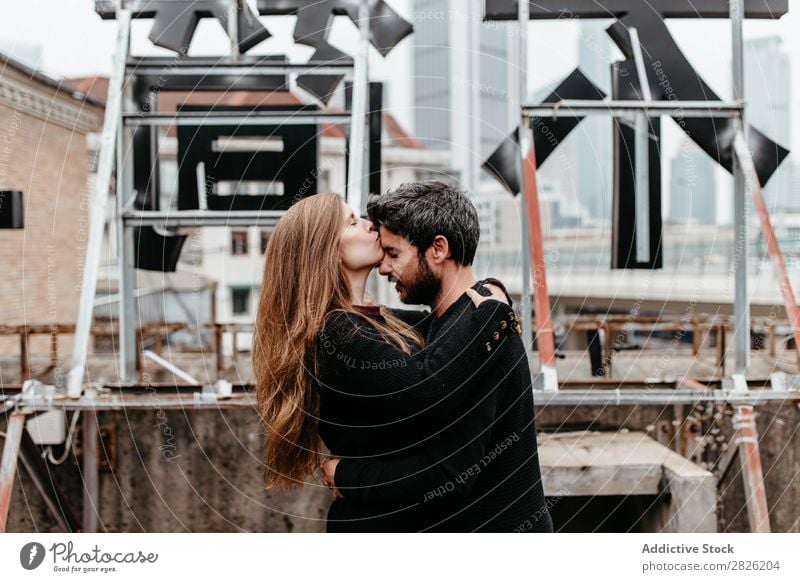 Male and female embrace on rooftop Couple Embrace City Love Vantage point Kissing Happy romantic Together Beautiful Youth (Young adults) Man Woman Romance