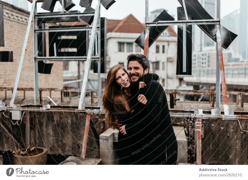 Happy couple on rooftop Couple Smiling Cuddling Embrace Skyline Stand Love romantic Together Beautiful Youth (Young adults) Man Woman Romance Girl Caucasian