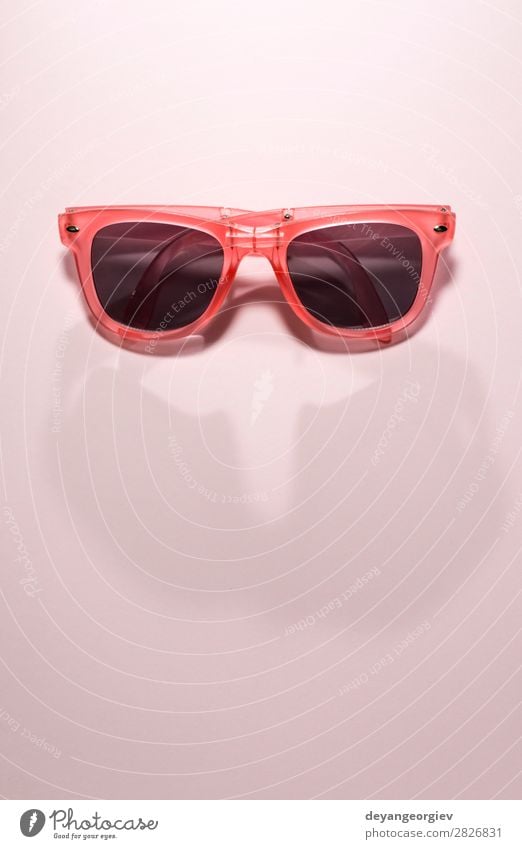 Red bright sunglasses on a pastel pink background. Summer time Style Design Vacation & Travel Sun Beach Art Fashion Accessory Sunglasses Plastic Bright