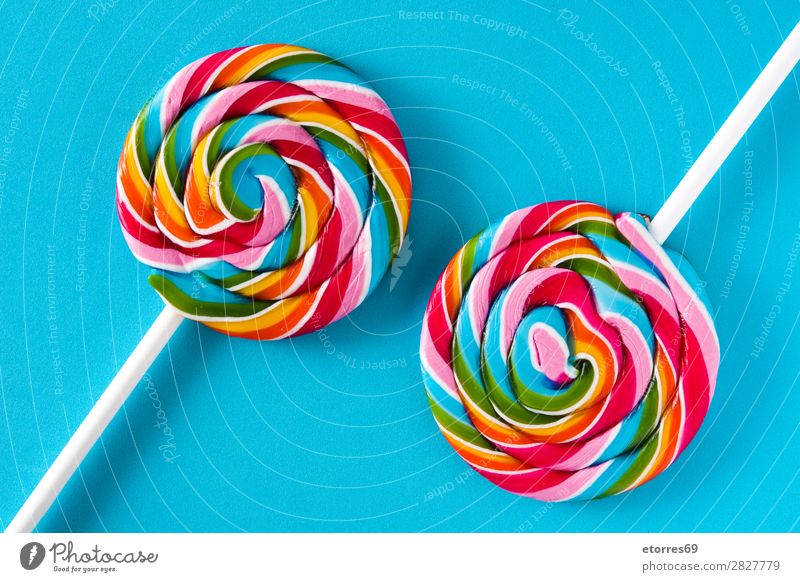 Colorful lollipops on blue background. Lollipop Colour Multicoloured Sugar Candy Sweet Tasty Neutral Background Copy Space Food Healthy Eating Food photograph