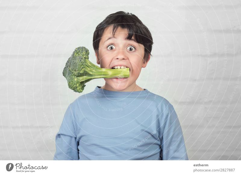 Happy child with broccoli in his mouth against brick background Vegetable Nutrition Eating Lunch Vegetarian diet Diet Lifestyle Healthy Eating Human being