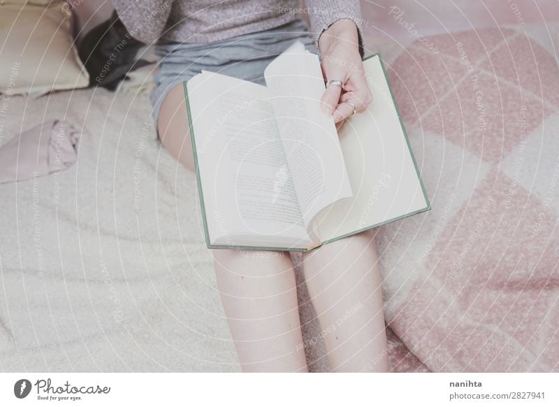 Young woman reading in her room Lifestyle Style Relaxation Calm Leisure and hobbies Reading Bedroom Education Study Student Feminine Woman Adults Legs Art