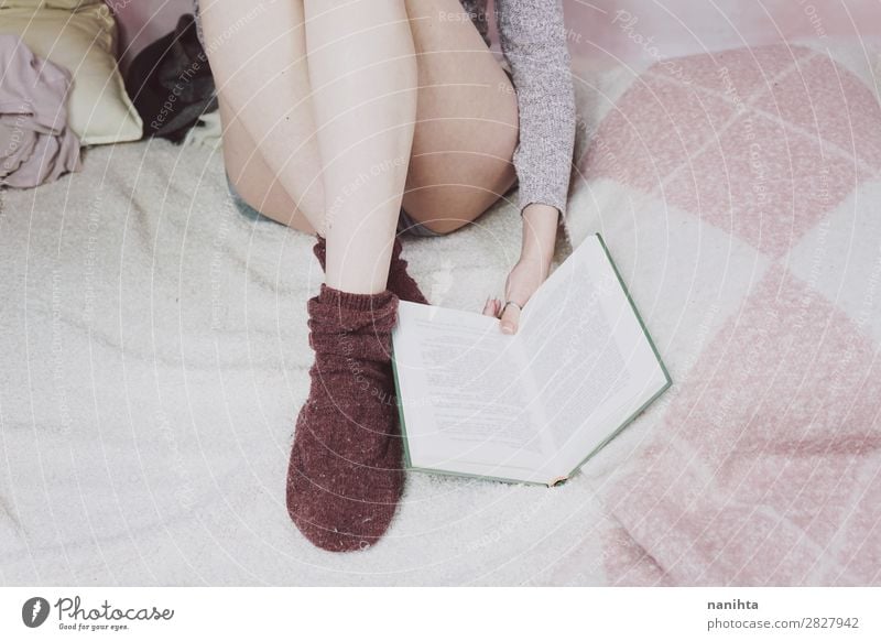 Young woman reading a book in her bedroom Lifestyle Relaxation Calm Leisure and hobbies Reading Bedroom Student Feminine Youth (Young adults) Woman Adults Legs