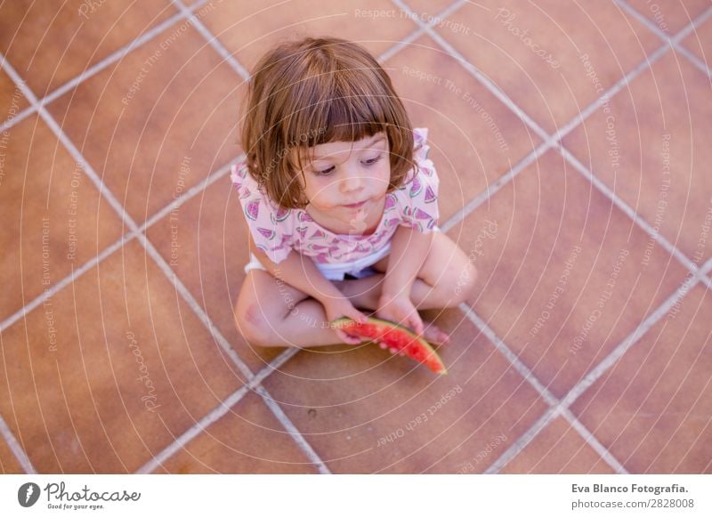 top view of a Beautiful kid girl eating watermelon Fruit Ice cream Eating Joy Happy Vacation & Travel Summer House (Residential Structure) Garden Child Feminine